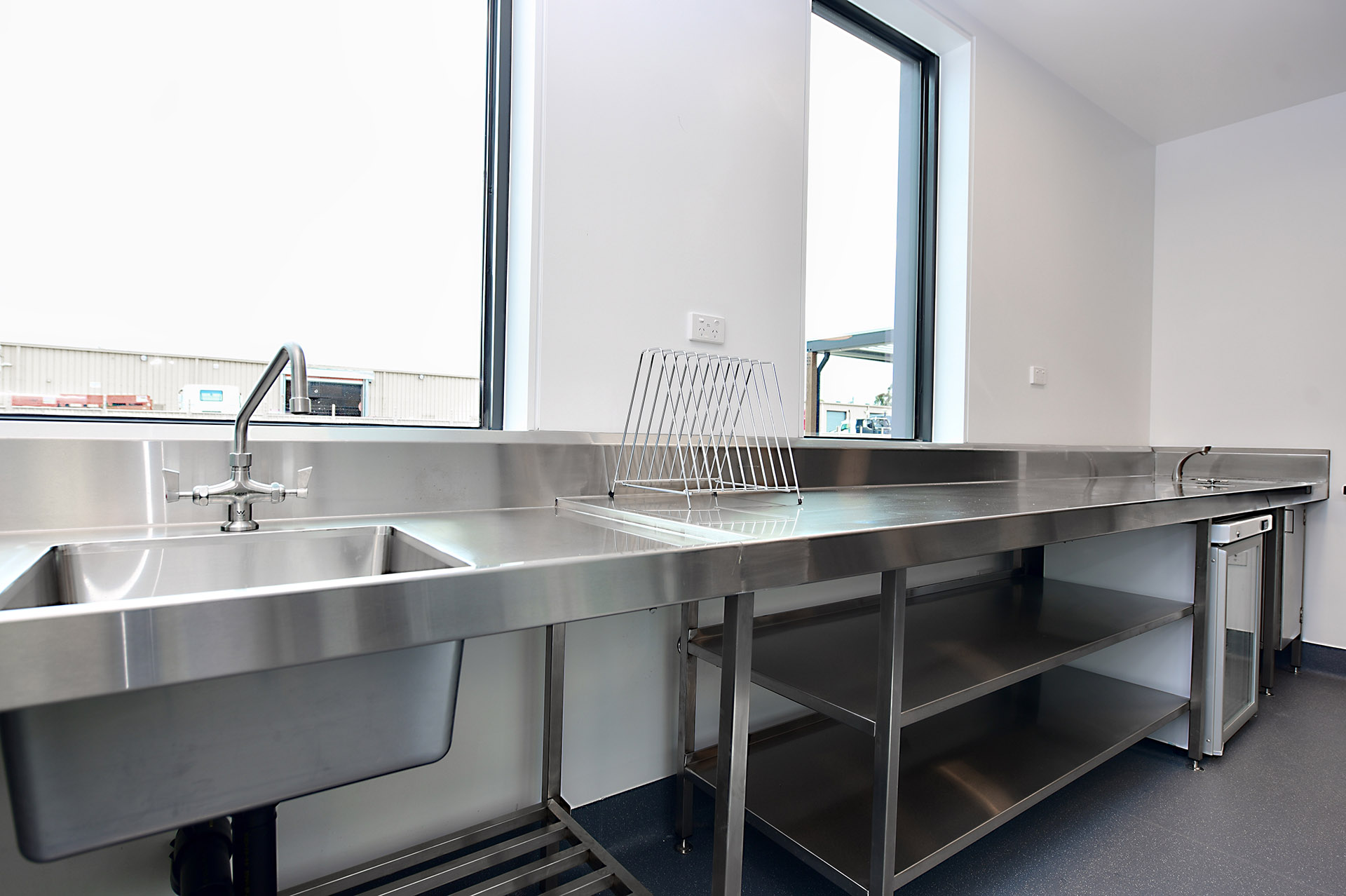Stainless steel sinks and wall cladding